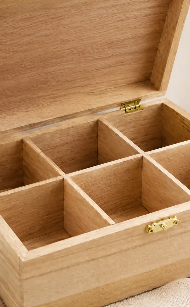 Interior of a wooden box with six compartments and brass latch