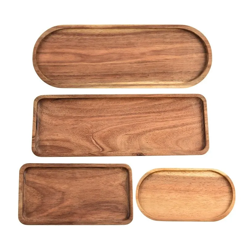 Set of four acacia wood trays in oval and rectangular shapes