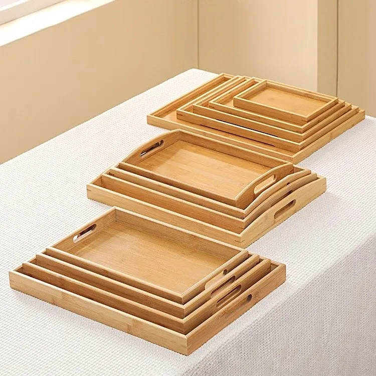 Nested set of bamboo trays in graduated sizes on a white cloth