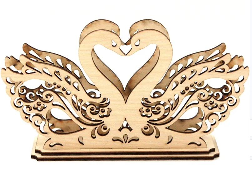 Laser-cut wooden swan pair ornament with heart-shaped neck and wings on a base
